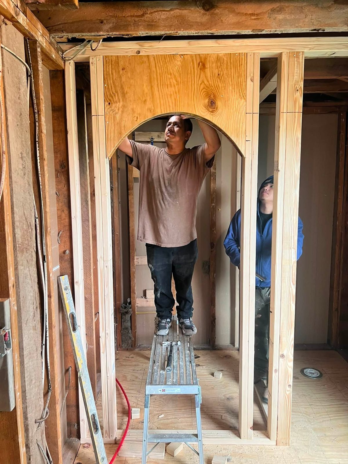 Crew framing a new arched doorway